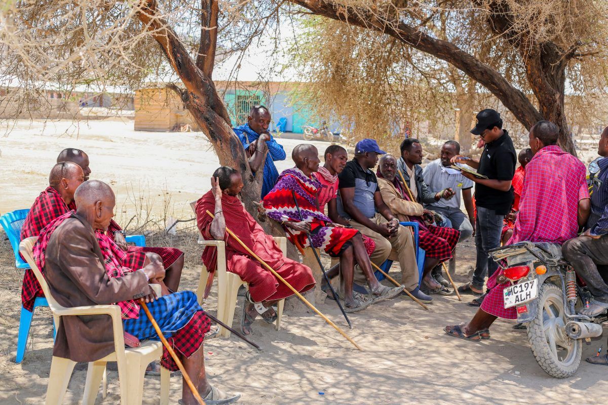 Community elders meeting under a tree inside a Wildlife Management Area